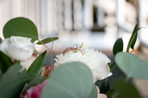 Wedding rings inside of flower in bridal bouquet