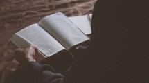 college student reading a Bible 