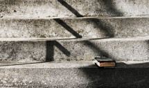 a Bible on concrete steps