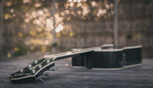 guitar on a wood table outdoors 
