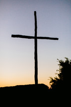 Silhouette of a cross at dusk.