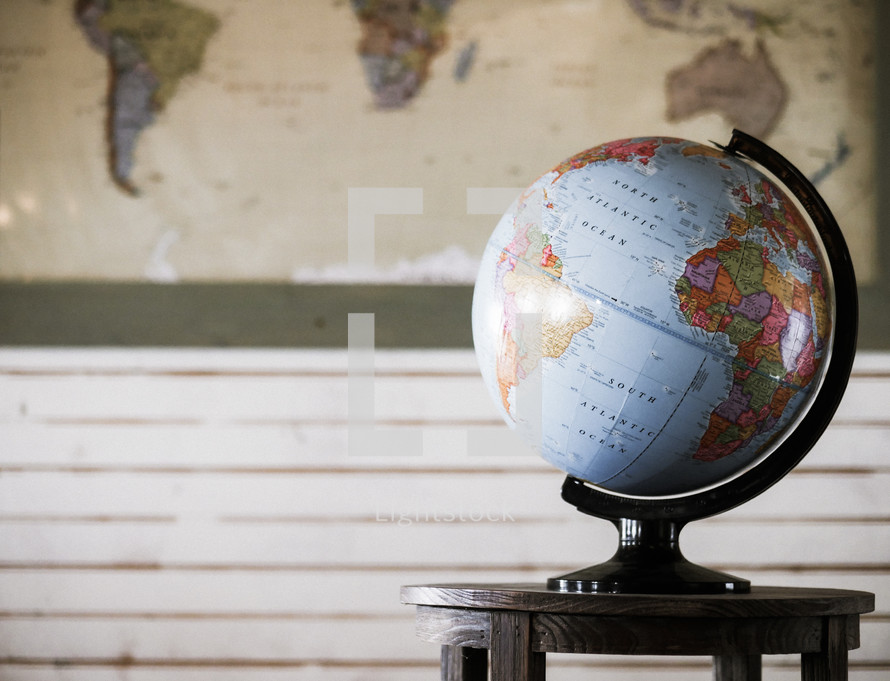 globe on a table and a world map 