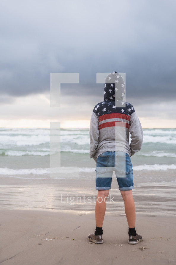 boy standing on a beach 