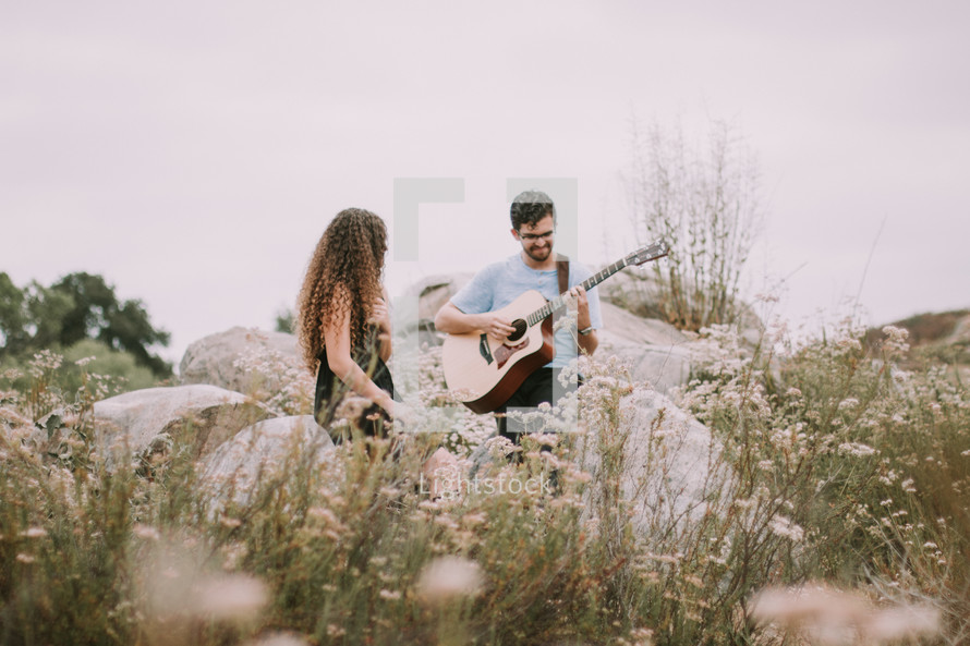 a man serenading a woman outdoors 