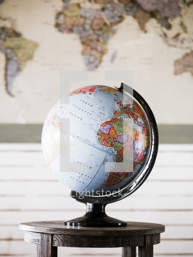world map and a globe on a table 