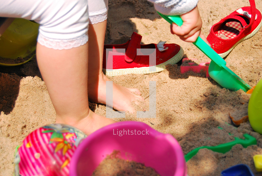 kids playing in the sand with sand toys 