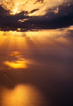 rays of sunbeams over the ocean at sunset 