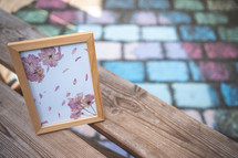 frame with flowers on a bench 