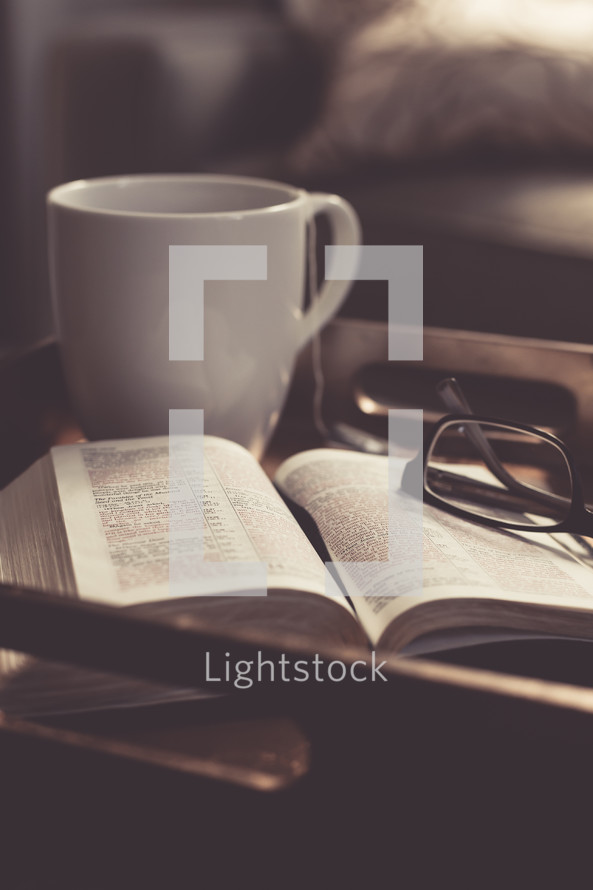 Tea cup, Bible, and reading glasses on a tray