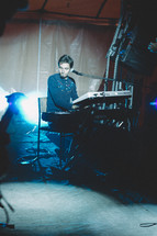 man playing a keyboard on stage 