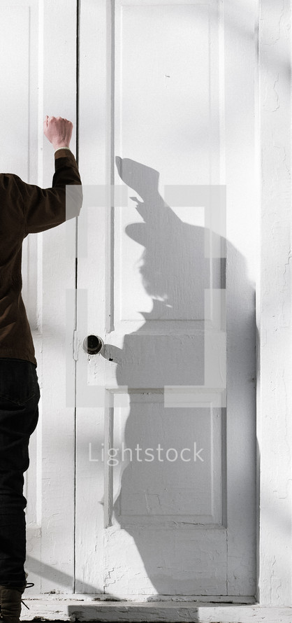 a woman knocking on church doors 