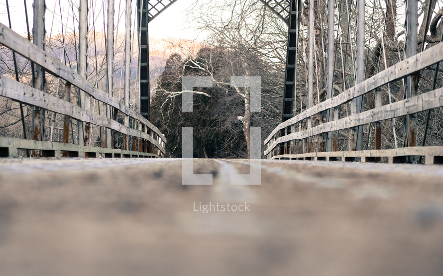 cross over a bridge on a hike in winter 