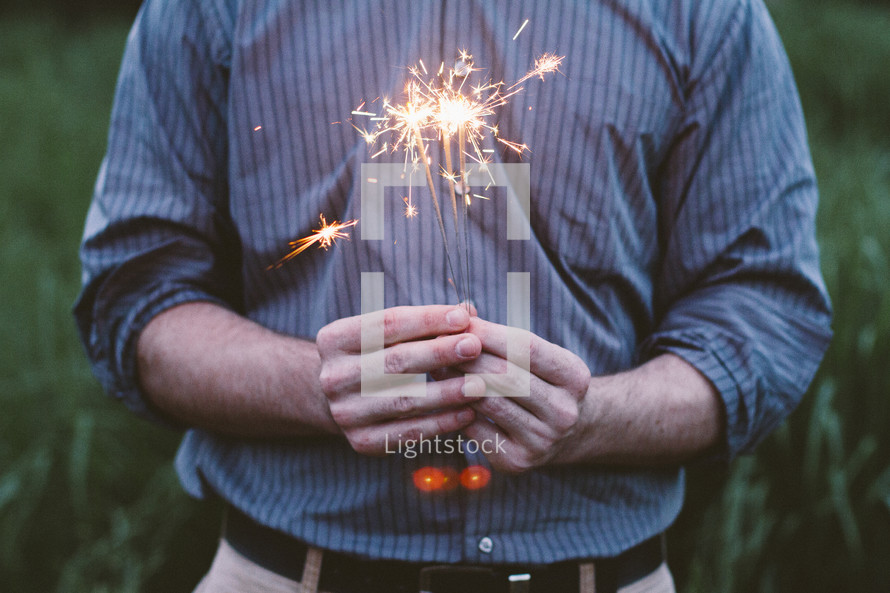 man holding a sparkler 