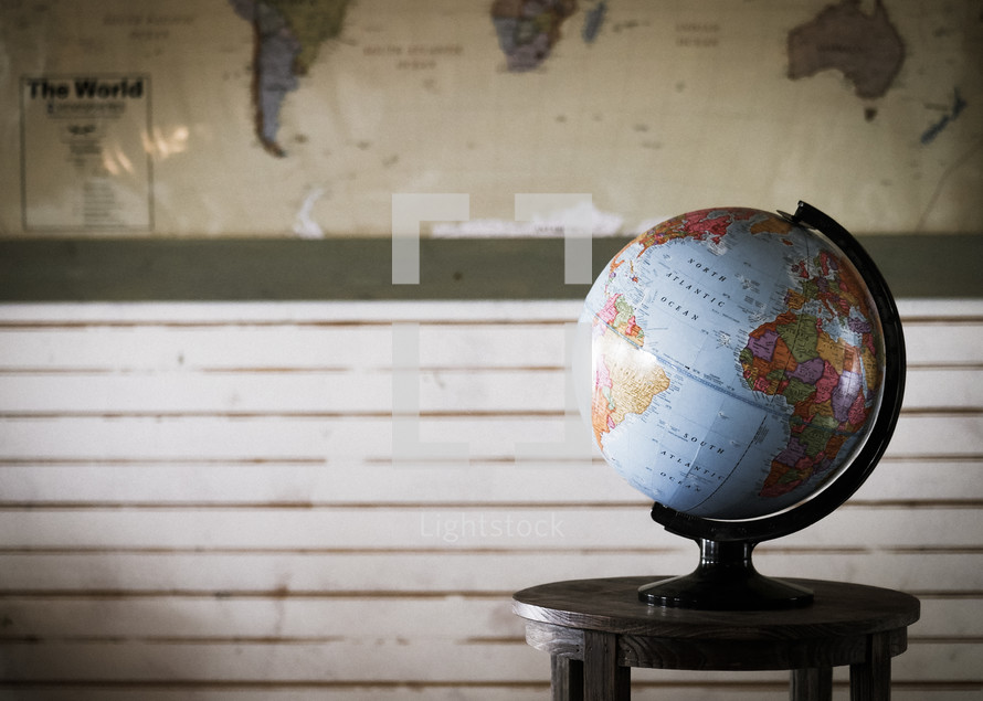 world map and a globe on a table 