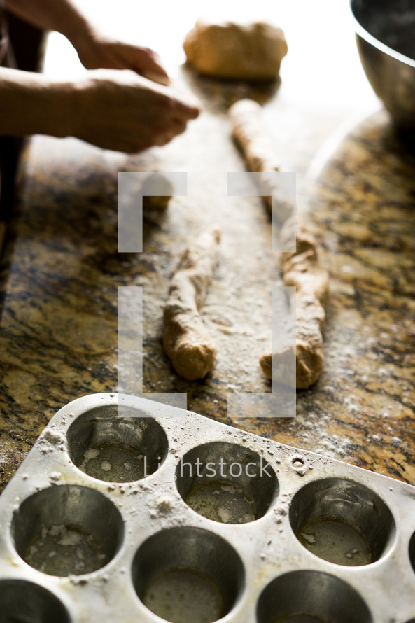 a woman rolling dough in the kitchen 
