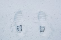 Shoe prints in the snow.