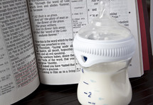 Baby bottle and a Bible