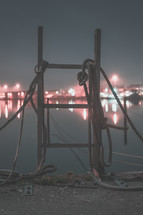 rope on a ladder on a dock at night 