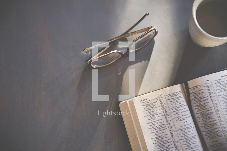 reading glasses and an open Bible 