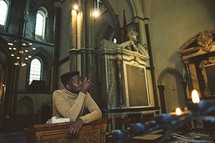 man at a pulpit in prayer