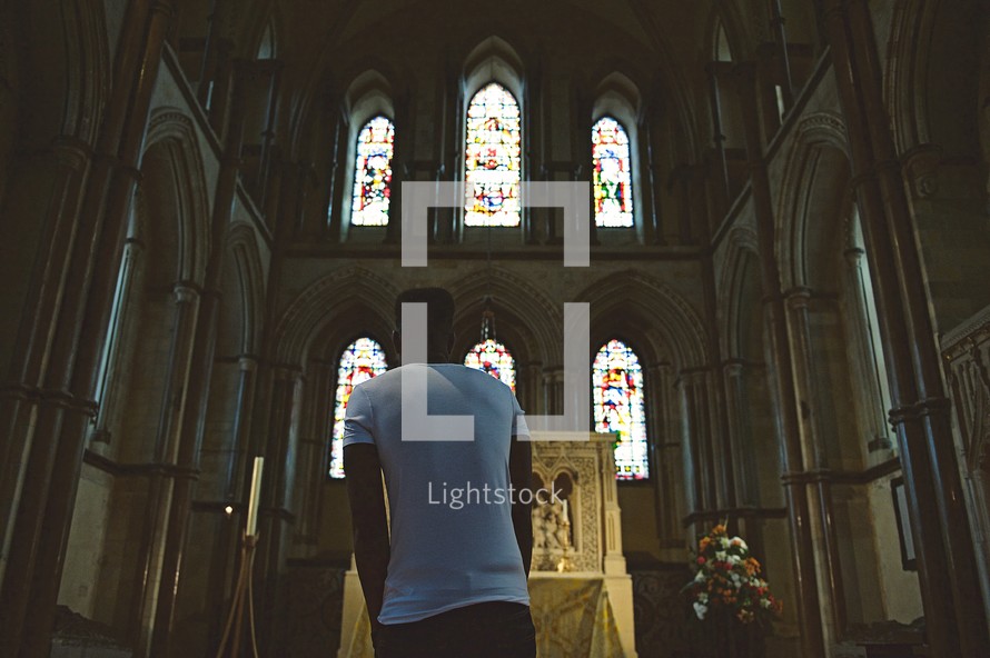 man approaching an altar in a Catholic church 