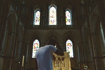 man standing in front of an altar ashamed 