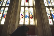 man seeking forgiveness in prayer in a church