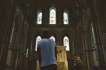 man approaching an altar in a Catholic church 