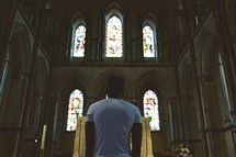 man approaching an altar in a church 