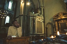 a man at the pulpit thinking inside an empty church 