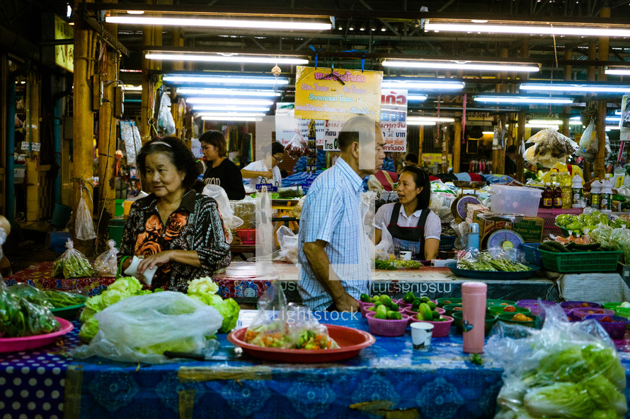 vendors and shoppers at a market 