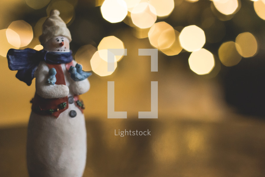 snowman figurine and bokeh lights 