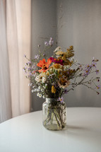 vase of picked flowers on a white table 
