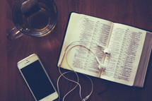 iphone, ear buds, tea, and a Bible 