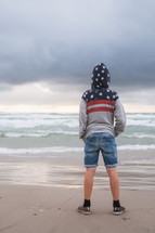boy standing on a beach 