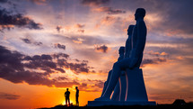 silhouettes and statues at sunset 
