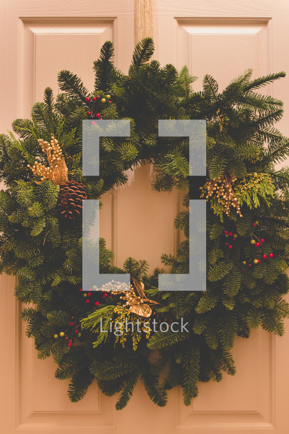 A Christmas wreath on a door. 
