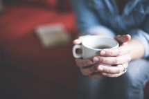 a woman holding a mug of coffee