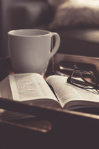 Tea cup, Bible, and reading glasses on a tray