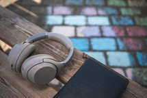 headphones and Bible on a bench with sidewalk chalk 