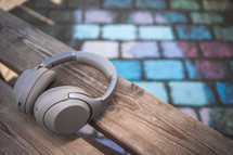 headphones on a bench and colored sidewalk chalk 