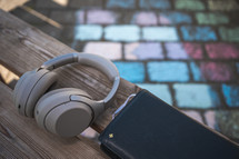 headphones and Bible on a bench with sidewalk chalk 