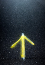 spray painted arrow on asphalt 