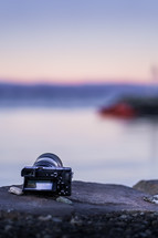 camera sitting on a rock 