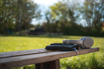 Bible and headphones outdoors 