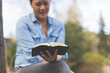 A woman reading a Bible 