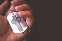 A cross on a dog tag. 