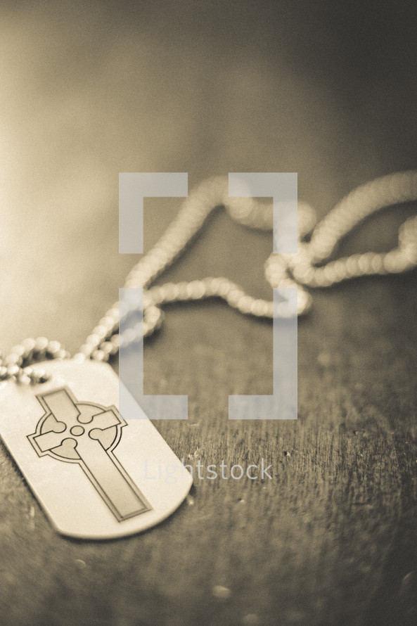 A dog tag with a cross