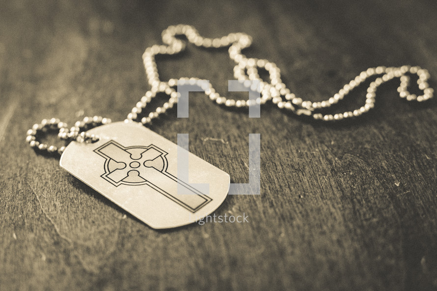 A dog tag with a cross
