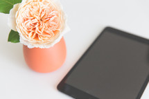 peach flower in a vase and iPad 
